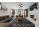 Bright living room with fireplace, modern ceiling fan, neutral decor, and wood flooring at 407 Calgary Dr, Peachtree City, GA 30269