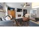 Cozy living room with a fireplace, comfortable seating, and stylish decor with a view to the dining room at 407 Calgary Dr, Peachtree City, GA 30269