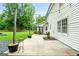 Backyard patio with outdoor dining set and lush green lawn at 407 Calgary Dr, Peachtree City, GA 30269