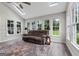 Bright sunroom with lots of natural light, ceiling fan, and a cozy couch at 407 Calgary Dr, Peachtree City, GA 30269