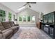Sunroom with a large couch, an area rug, and lots of natural light at 407 Calgary Dr, Peachtree City, GA 30269