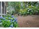 Lush backyard featuring colorful hydrangeas and mature trees creating a beautiful and private outdoor space at 795 Lake Medlock, Alpharetta, GA 30022
