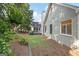 Side view of home and backyard featuring lush trees and manicured landscaping for a serene outdoor setting at 795 Lake Medlock, Alpharetta, GA 30022