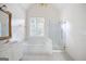 Bright bathroom featuring a soaking tub, glass shower, and white vanity with gold fixtures at 795 Lake Medlock, Alpharetta, GA 30022