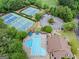 Aerial view showcasing a community pool, clubhouse, tennis courts, and lush landscaping at 795 Lake Medlock, Alpharetta, GA 30022
