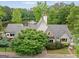 Charming home with stone accents, a well-manicured lawn, and a picturesque pond view at 795 Lake Medlock, Alpharetta, GA 30022
