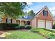 Charming brick home featuring a well-manicured lawn and two-car garage at 795 Lake Medlock, Alpharetta, GA 30022