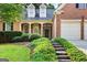 Charming brick home featuring a well-manicured lawn and lush landscaping at 795 Lake Medlock, Alpharetta, GA 30022