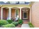 Inviting brick front porch with decorative columns and well-kept landscaping at 795 Lake Medlock, Alpharetta, GA 30022