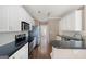 Kitchen featuring granite countertops, stainless steel appliances, white cabinets, and hardwood floors at 795 Lake Medlock, Alpharetta, GA 30022