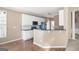 Kitchen featuring white cabinets, black countertops, hardwood floors, and stainless steel appliances at 795 Lake Medlock, Alpharetta, GA 30022