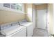 Laundry room featuring washer, dryer, shelving and tile floors at 795 Lake Medlock, Alpharetta, GA 30022