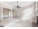 Bright living room with plush carpeting, wainscoting, and decorative pillars at 795 Lake Medlock, Alpharetta, GA 30022