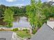 Scenic aerial view of pond with a fountain, surrounded by mature trees and a well-maintained landscape at 795 Lake Medlock, Alpharetta, GA 30022