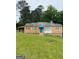 Charming single-story home featuring a quaint blue door and complemented by a well-maintained, expansive lawn at 5094 Covington Hwy, Decatur, GA 30035