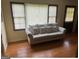 Bright living area featuring hardwood floors, a large sofa, and sunlight streaming in through the windows at 5094 Covington Hwy, Decatur, GA 30035