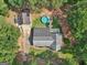 Aerial view of house with pool, detached garage, long driveway, and surrounded by green trees at 130 Emerald Dr, Mcdonough, GA 30253