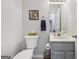 Cozy bathroom with gray vanity, toilet and artistic 'K' wall art at 130 Emerald Dr, Mcdonough, GA 30253