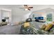 This bedroom includes carpet, ceiling fan, two windows, a bed, and a small play area at 130 Emerald Dr, Mcdonough, GA 30253