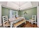 Charming dining room features a wooden table with benches and chairs, and a decorative chandelier at 130 Emerald Dr, Mcdonough, GA 30253