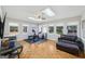 Bright exercise room features skylights, parquet floors, exercise bike, weights and a comfortable leather couch at 130 Emerald Dr, Mcdonough, GA 30253