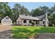 Charming brick home with well-maintained lawn and a detached garage offering ample space at 130 Emerald Dr, Mcdonough, GA 30253