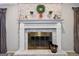 Close-up of the fireplace mantel with decor against the brick wall and hearth at 130 Emerald Dr, Mcdonough, GA 30253
