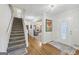 Inviting foyer with hardwood floors, a staircase, and an open view into the living area at 130 Emerald Dr, Mcdonough, GA 30253