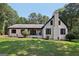 Charming white brick home with manicured landscaping and a covered front porch entrance at 130 Emerald Dr, Mcdonough, GA 30253