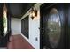 Close-up of the front door and sidelight on the front porch, accented by a stylish outdoor lantern at 130 Emerald Dr, Mcdonough, GA 30253