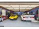 Spacious garage featuring vintage cars and well-organized storage, perfect for car enthusiasts at 130 Emerald Dr, Mcdonough, GA 30253