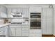 The kitchen includes stainless steel appliances, light gray cabinetry, and stone countertops at 130 Emerald Dr, Mcdonough, GA 30253