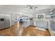 Bright kitchen with stainless steel appliances, light gray cabinets, and hardwood floors at 130 Emerald Dr, Mcdonough, GA 30253