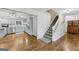 Updated kitchen with gray cabinets, modern appliances, and hardwood floors leads to the staircase at 130 Emerald Dr, Mcdonough, GA 30253