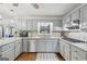 A well-appointed kitchen with light-colored cabinets, stone countertops, and stainless steel appliances at 130 Emerald Dr, Mcdonough, GA 30253