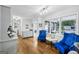 Bright living room with hardwood floors, blue chairs, and ample natural light at 130 Emerald Dr, Mcdonough, GA 30253