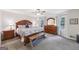 Spacious main bedroom suite features an ornate wood bed frame, a bench, and dresser with a mirror at 130 Emerald Dr, Mcdonough, GA 30253