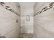 Stylish shower with pebble flooring, tile walls, and built-in niche at 130 Emerald Dr, Mcdonough, GA 30253