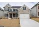 Attractive two-story home with a brick and siding exterior and an attached two-car garage with a long driveway at 3468 Jasmine Sw Way, South Fulton, GA 30331