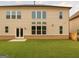 Exterior view of the home's backyard, featuring a well-maintained lawn and patio at 3468 Jasmine Sw Way, South Fulton, GA 30331