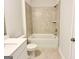 Clean bathroom featuring a bathtub with tile surround, a single sink vanity, tile floors, and updated fixtures at 3468 Jasmine Way Sw, South Fulton, GA 30331