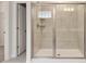 New bathroom featuring a glass shower with tiled walls, shelving and two built in seats at 3468 Jasmine Way Sw, South Fulton, GA 30331
