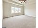 Large primary bedroom featuring a ceiling fan and multiple windows with beautiful views at 3468 Jasmine Way Sw, South Fulton, GA 30331