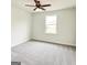 Cozy bedroom featuring plush carpet, a ceiling fan, neutral paint, and natural light from the window at 3468 Jasmine Way Sw, South Fulton, GA 30331