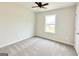 Bright, neutral-toned bedroom with window, plush carpeting, and white door at 3468 Jasmine Way Sw, South Fulton, GA 30331