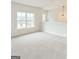 Spacious bonus room with large windows providing natural light and neutral carpeting throughout at 3468 Jasmine Way Sw, South Fulton, GA 30331