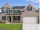 Charming two-story home with a brick facade, black shutters, well-manicured lawn, and attached two car garage at 3468 Jasmine Way Sw, South Fulton, GA 30331
