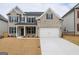 Attractive two-story home with a brick facade, black shutters, and an attached two-car garage on a large lot at 3468 Jasmine Way Sw, South Fulton, GA 30331