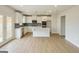 Modern kitchen with white cabinets, stainless steel appliances, an island, and wood-look floors at 3468 Jasmine Way Sw, South Fulton, GA 30331