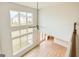 Bright living room with wood-look floors, large windows, and high ceilings offering backyard views at 3468 Jasmine Way Sw, South Fulton, GA 30331